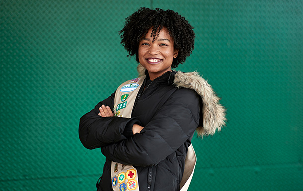 ambassador high school girl scout wearing sash outside against green background ambassador high school girl scout wearing sash outside against green background